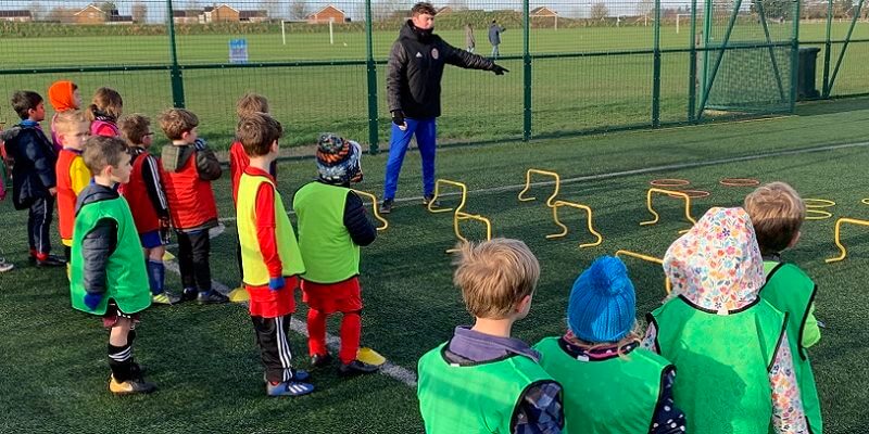 Fiesta sports coaching children at a football session