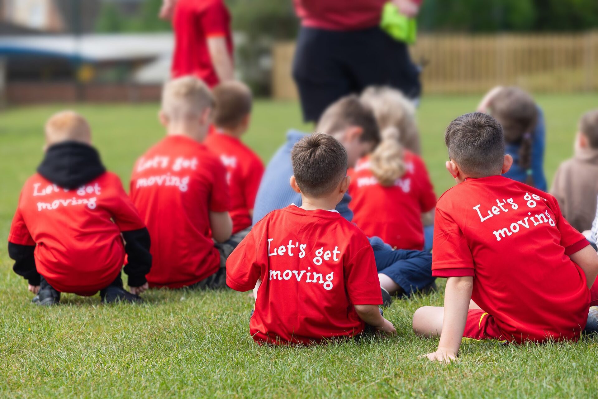 Group of children sitting on football pitch